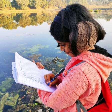 Child noting down observations
